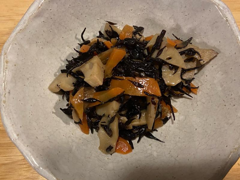 Close-up of Hijiki Nimono, a Japanese simmered hijiki seaweed dish with carrots and lotus root, served in a ceramic bowl.